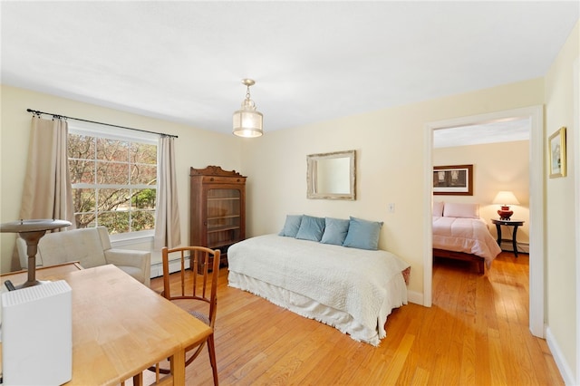 29 Howard Ave, Scituate, RI 02831 - bedroom with light wood-type flooring, a baseboard radiator, and baseboards