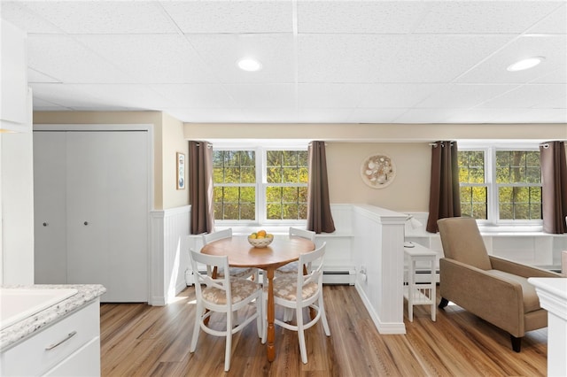 29 Howard Ave, Scituate, RI 02831 - dining room with light wood-style floors, a wainscoted wall, and baseboard heating
