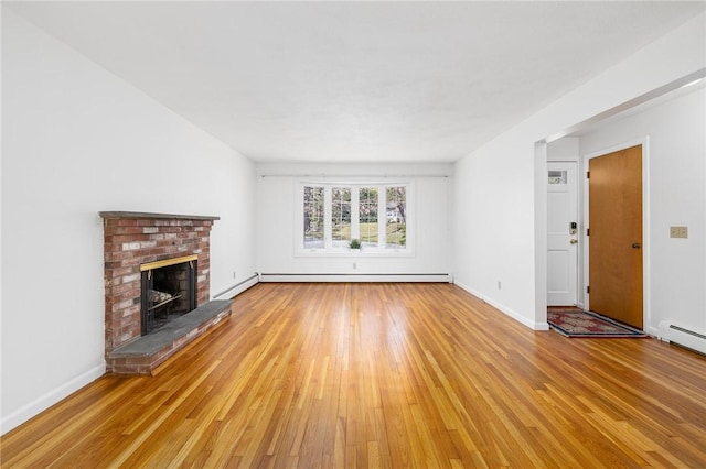 unfurnished living room with baseboards, a brick fireplace, light wood finished floors, and a baseboard heating unit