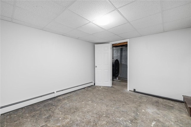 spare room with a paneled ceiling and a baseboard radiator