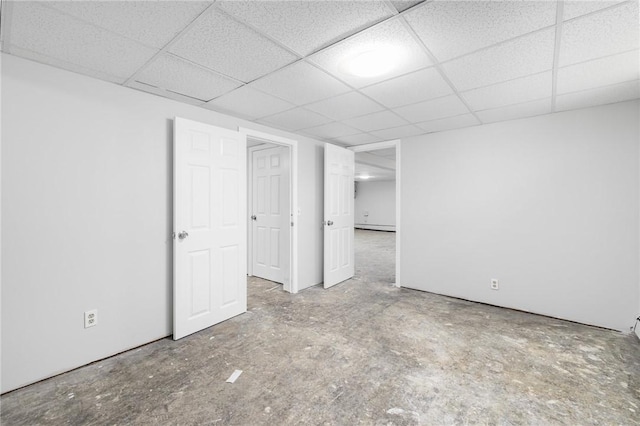 finished below grade area with baseboard heating and a paneled ceiling