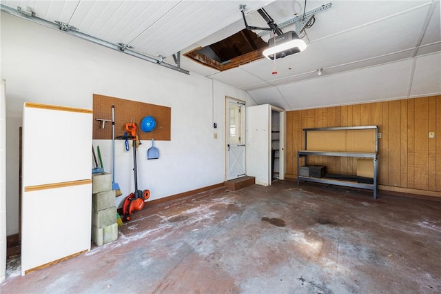 garage with a garage door opener and wooden walls