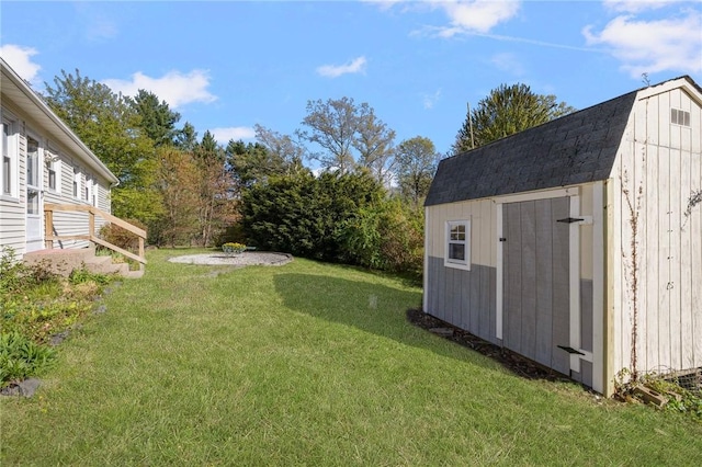 view of yard with a storage unit and an outbuilding