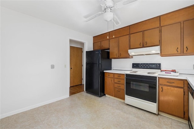 kitchen featuring electric range, ceiling fan, light countertops, freestanding refrigerator, and under cabinet range hood