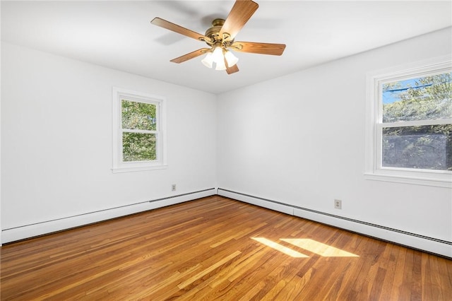 spare room featuring ceiling fan, wood finished floors, and a baseboard radiator