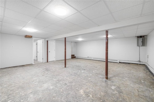 finished below grade area with baseboard heating, a paneled ceiling, and stairway