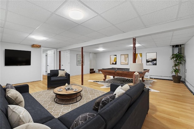living area featuring pool table, baseboard heating, wood finished floors, and a paneled ceiling