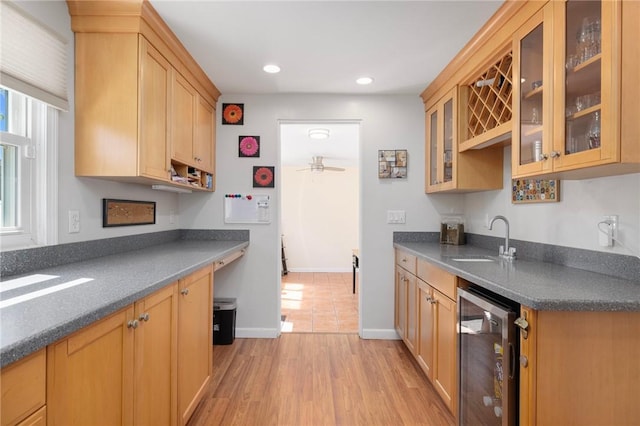 289 Oliphant Ln, Middletown, RI 02842 - kitchen featuring dark countertops, a sink, a ceiling fan, wine cooler, and glass insert cabinets