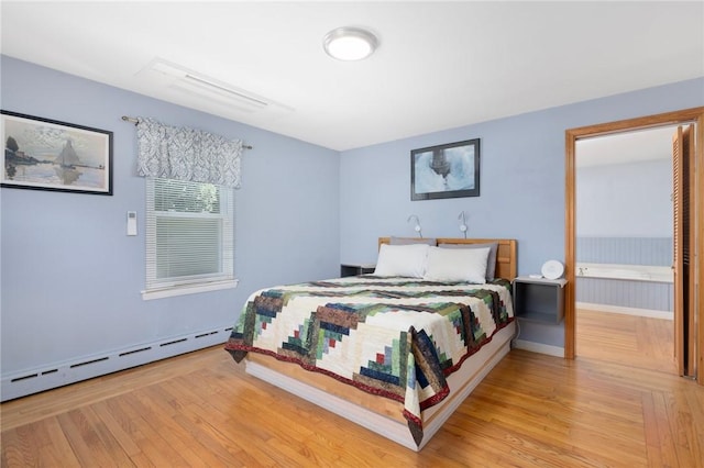 289 Oliphant Ln, Middletown, RI 02842 - bedroom featuring baseboards, a baseboard heating unit, and wood finished floors