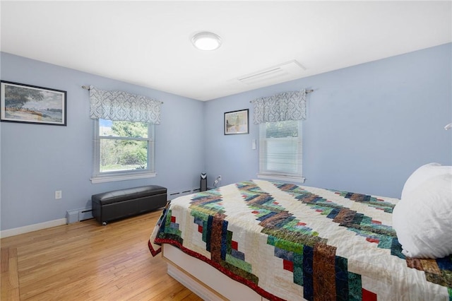 289 Oliphant Ln, Middletown, RI 02842 - bedroom with baseboards, light wood-style flooring, and a baseboard radiator