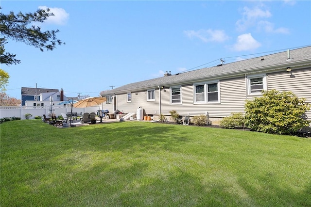 289 Oliphant Ln, Middletown, RI 02842 - rear view of house featuring a lawn, fence, and a patio area