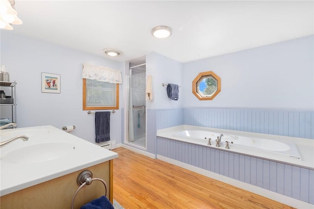 289 Oliphant Ln, Middletown, RI 02842 - full bathroom with a sink, a wainscoted wall, a shower stall, wood finished floors, and a bath