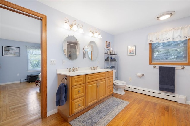 289 Oliphant Ln, Middletown, RI 02842 - full bathroom featuring a sink, a baseboard radiator, double vanity, and wood finished floors