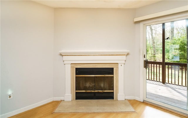 51 Scenic Dr, West Warwick, RI 02893 - room details featuring a glass covered fireplace, baseboards, and wood finished floors