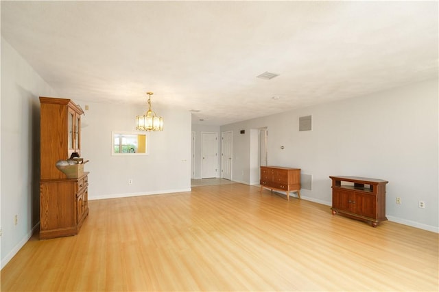 51 Scenic Dr, West Warwick, RI 02893 - empty room with baseboards, visible vents, light wood-style flooring, and a notable chandelier