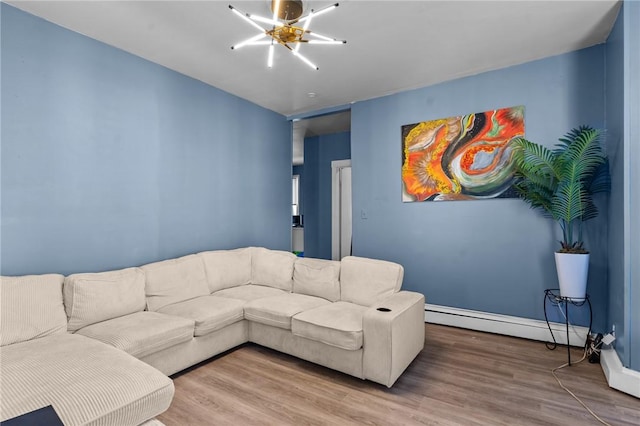 living area featuring baseboards, wood finished floors, and a baseboard radiator