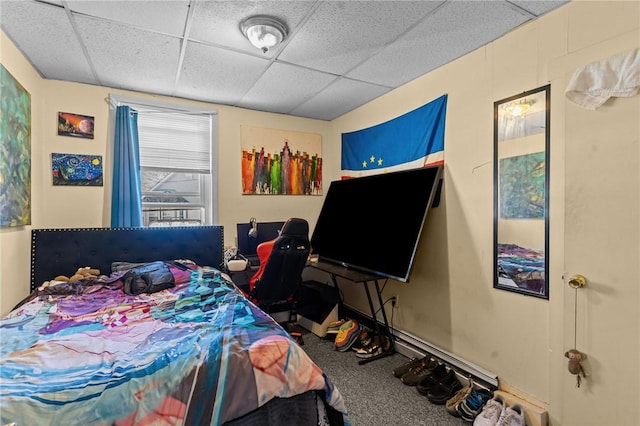 bedroom with carpet flooring and a drop ceiling