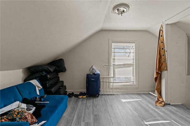 bonus room with baseboards, wood finished floors, and vaulted ceiling