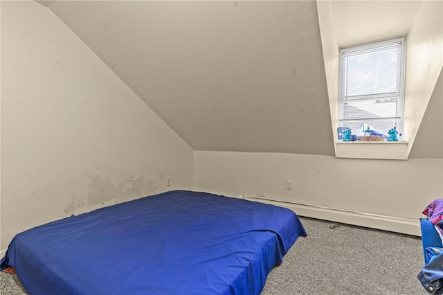 carpeted bedroom featuring baseboard heating and lofted ceiling