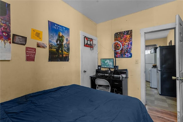 bedroom featuring freestanding refrigerator and tile patterned floors