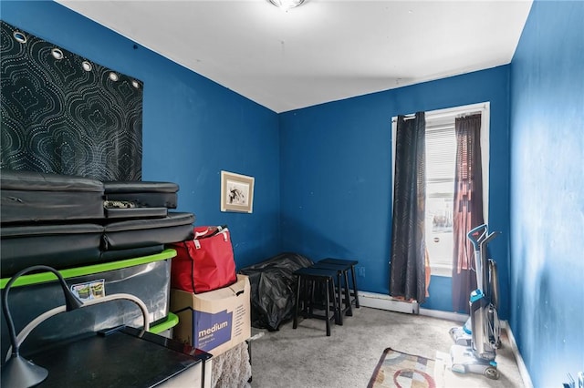 interior space featuring baseboard heating and carpet