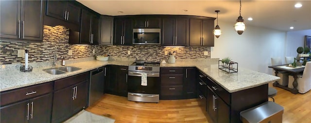 1 Tupperware Dr Unit 233, North Smithfield, RI 02896 - kitchen featuring stainless steel appliances, a sink, a peninsula, tasteful backsplash, and recessed lighting