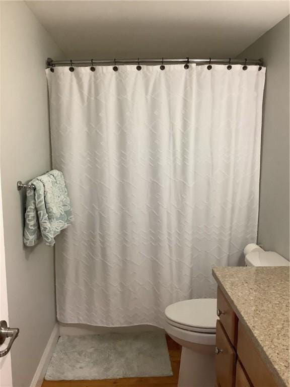 1 Tupperware Dr Unit 233, North Smithfield, RI 02896 - full bath featuring toilet, vanity, wood finished floors, baseboards, and curtained shower