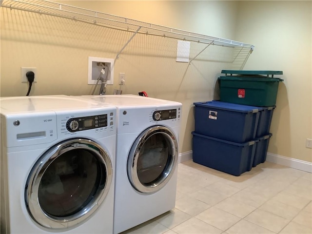 1 Tupperware Dr Unit 233, North Smithfield, RI 02896 - washroom featuring separate washer and dryer, light tile patterned flooring, and baseboards