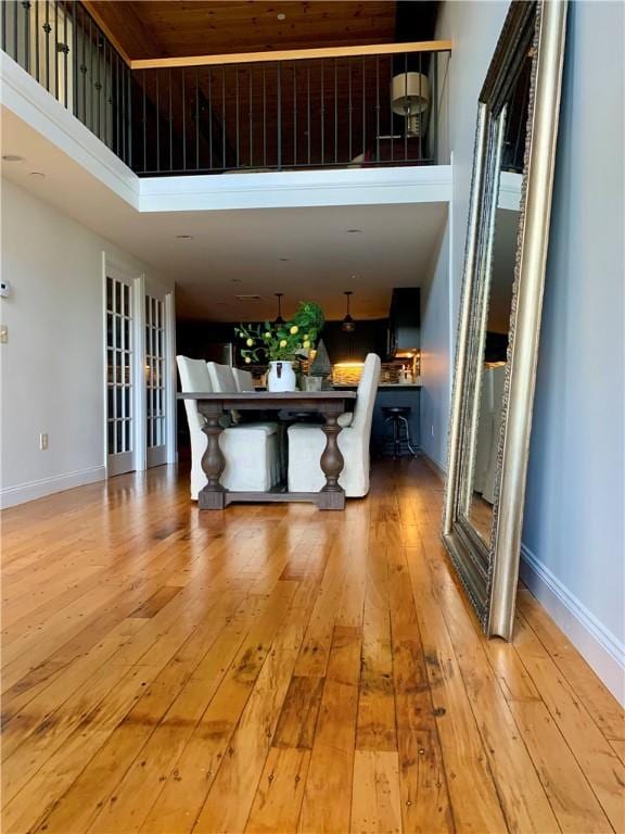 1 Tupperware Dr Unit 233, North Smithfield, RI 02896 - unfurnished dining area with wood-type flooring, a high ceiling, and baseboards