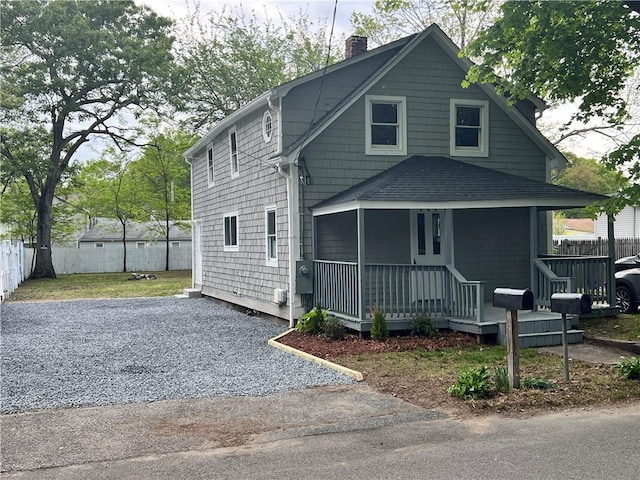 191 Canfield Ave, Warwick, RI 02889 - view of front of property featuring a chimney, a porch, fence, and roof with shingles