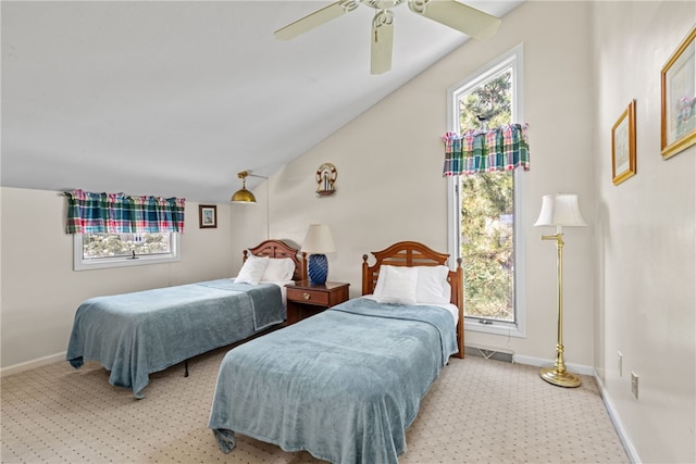 bedroom with light colored carpet, baseboards, and multiple windows