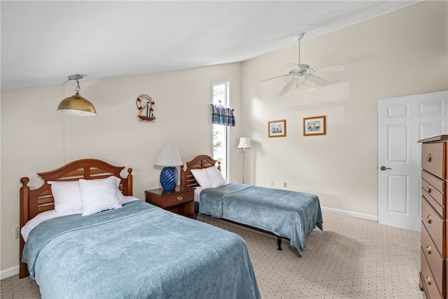 bedroom with baseboards, ceiling fan, light carpet, and vaulted ceiling