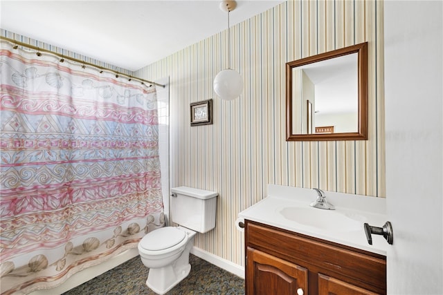 bathroom with vanity, toilet, baseboards, wallpapered walls, and shower / bath combo