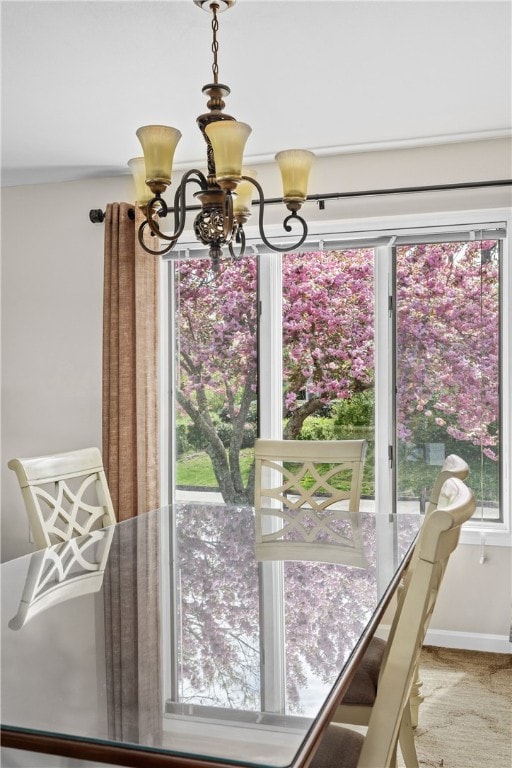 dining room with baseboards and a chandelier