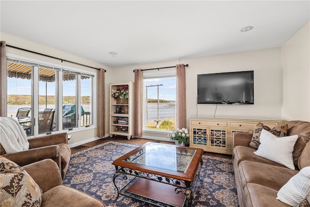 living room featuring baseboards, recessed lighting, and wood finished floors
