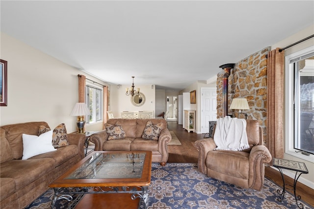 living area with baseboards, plenty of natural light, and wood finished floors