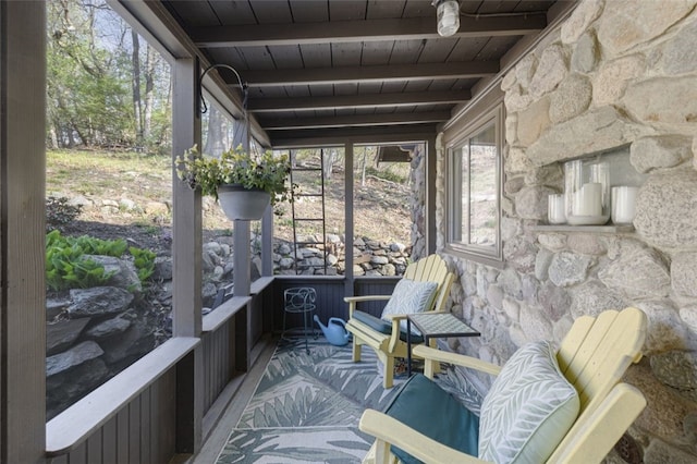 sunroom featuring a wealth of natural light and beamed ceiling