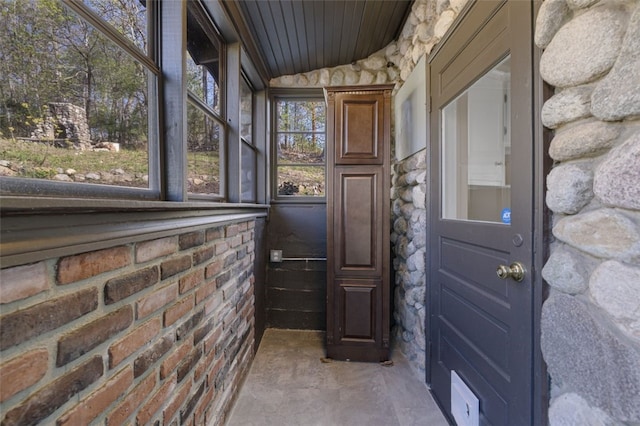doorway to outside with wooden ceiling
