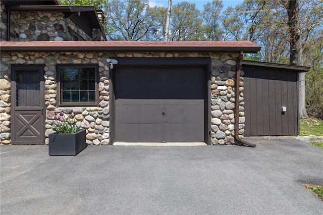 garage featuring aphalt driveway