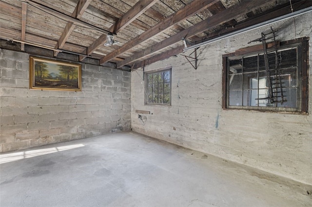 below grade area with concrete block wall and wooden ceiling