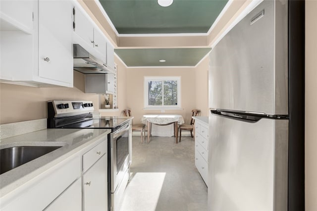 kitchen with white cabinets, light countertops, stainless steel appliances, finished concrete floors, and under cabinet range hood