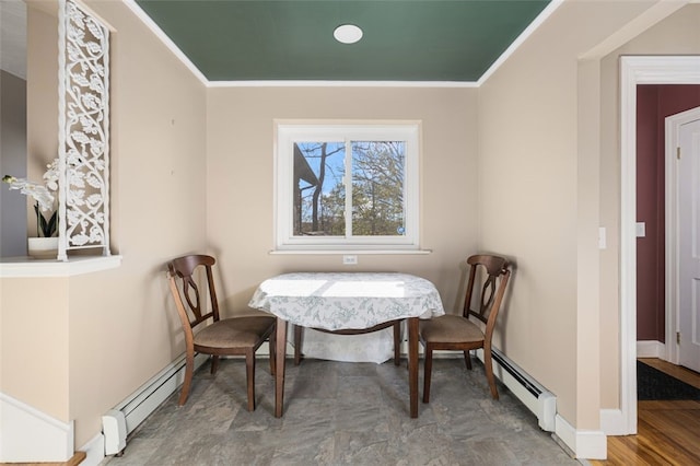 dining room featuring crown molding, baseboards, and baseboard heating