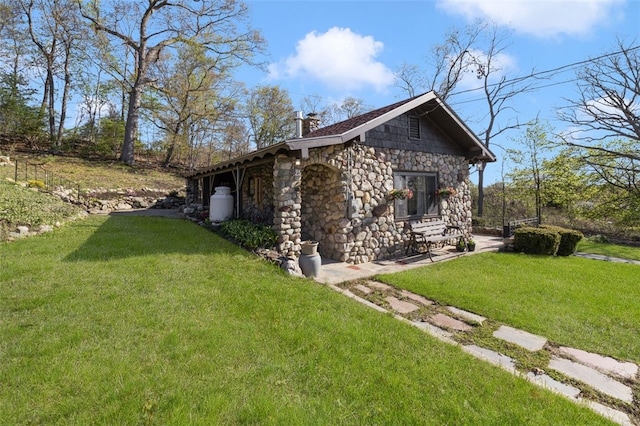 view of property exterior featuring a lawn, a chimney, and stone siding
