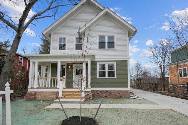 traditional-style home featuring covered porch
