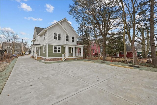 rear view of house featuring fence