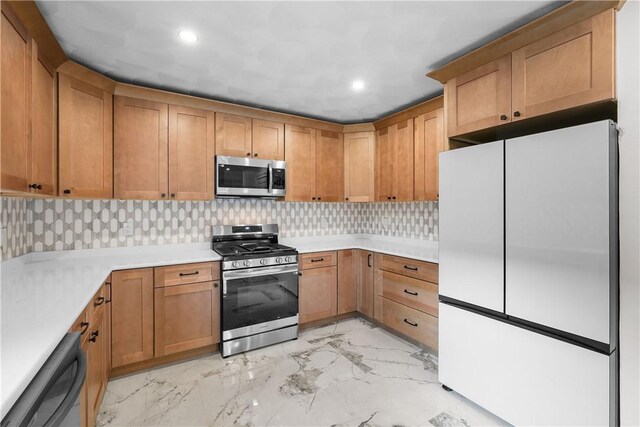 kitchen with light countertops, stainless steel appliances, recessed lighting, and marble finish floor
