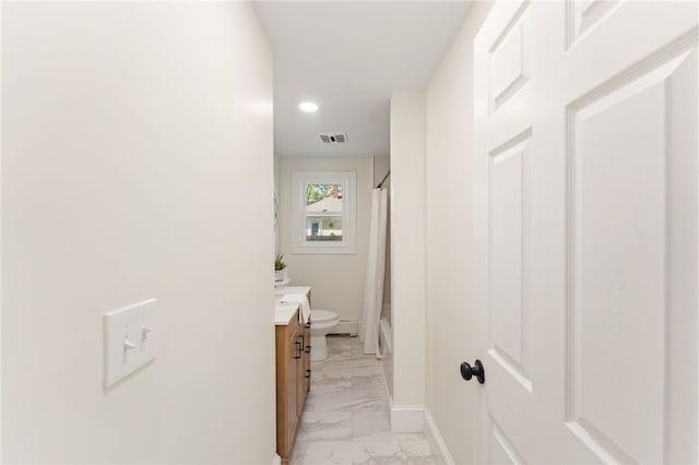 hallway with recessed lighting, baseboards, visible vents, and marble finish floor