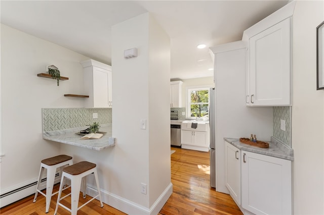 kitchen with stainless steel dishwasher, open shelves, white cabinets, and tasteful backsplash
