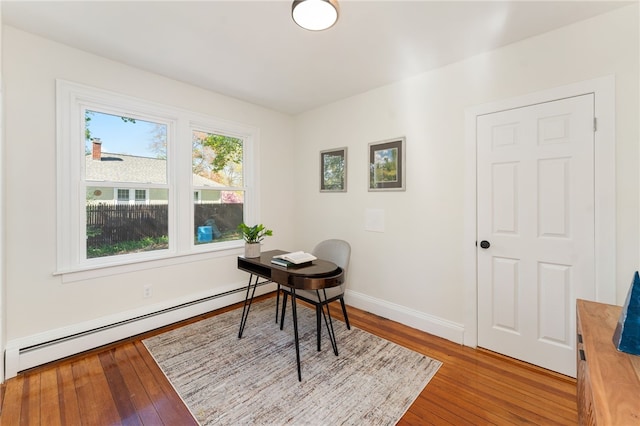 office featuring baseboards, a baseboard radiator, and hardwood / wood-style floors