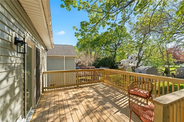 deck featuring a storage unit and an outbuilding